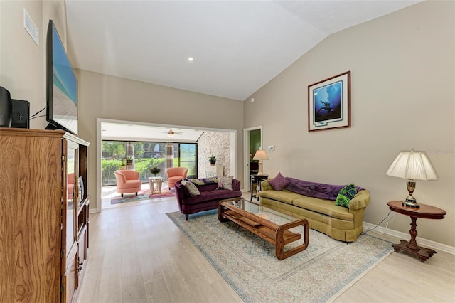 living room featuring hardwood / wood-style flooring, ceiling fan, and lofted ceiling