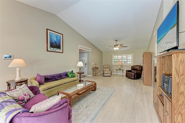 living room featuring ceiling fan, light hardwood / wood-style floors, and vaulted ceiling