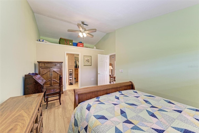 bedroom with ceiling fan, lofted ceiling, and light wood-type flooring