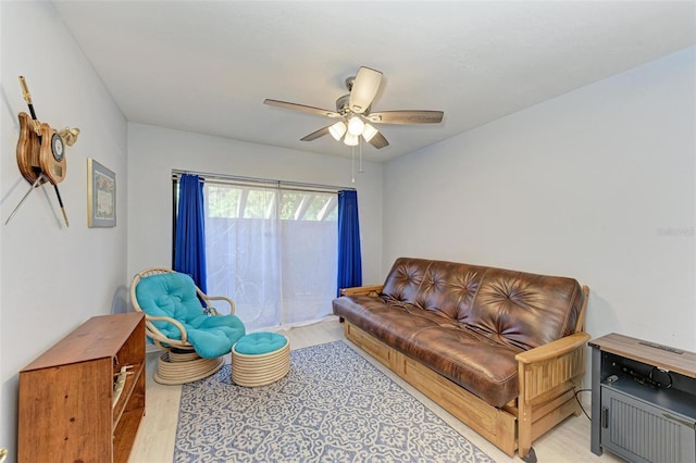 living room featuring ceiling fan and light wood-type flooring