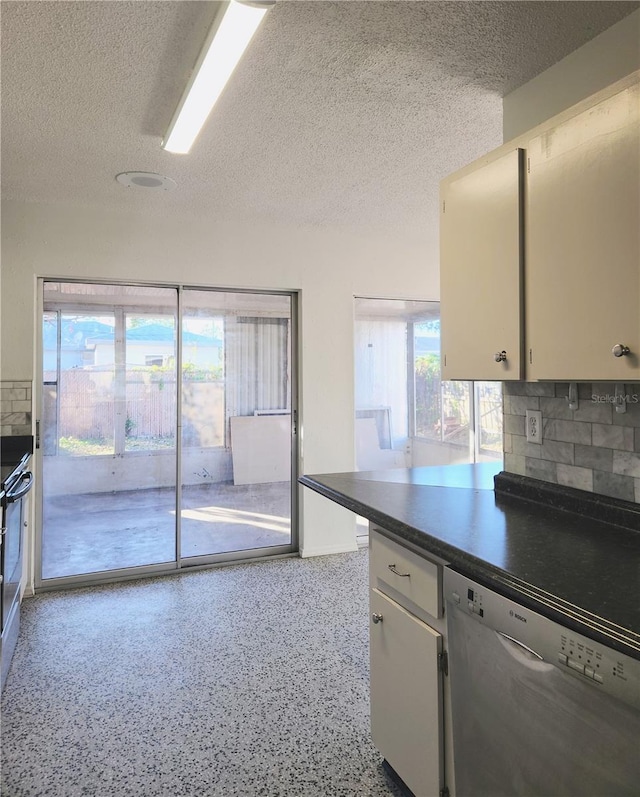 kitchen with dishwasher, decorative backsplash, white cabinetry, and a healthy amount of sunlight