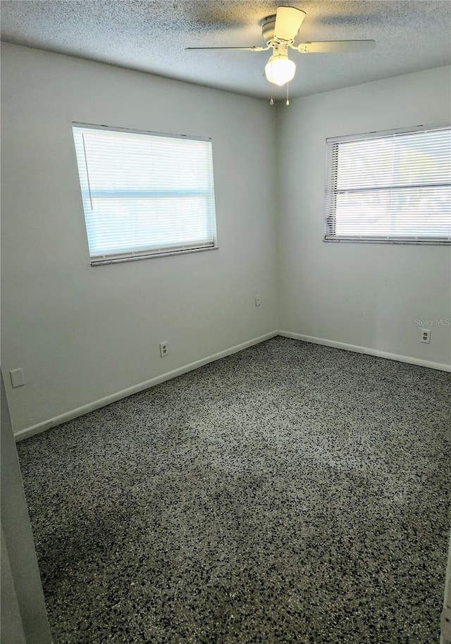 spare room featuring a textured ceiling and ceiling fan