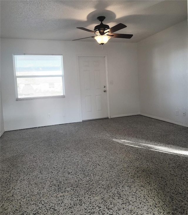 spare room featuring a textured ceiling and ceiling fan