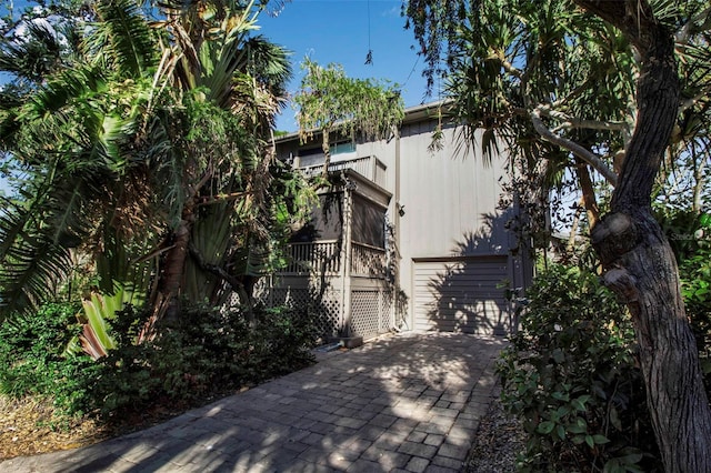 view of home's exterior featuring a balcony and a garage