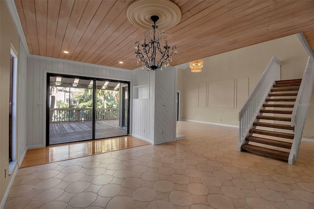 interior space featuring crown molding, wooden walls, wood ceiling, and a notable chandelier