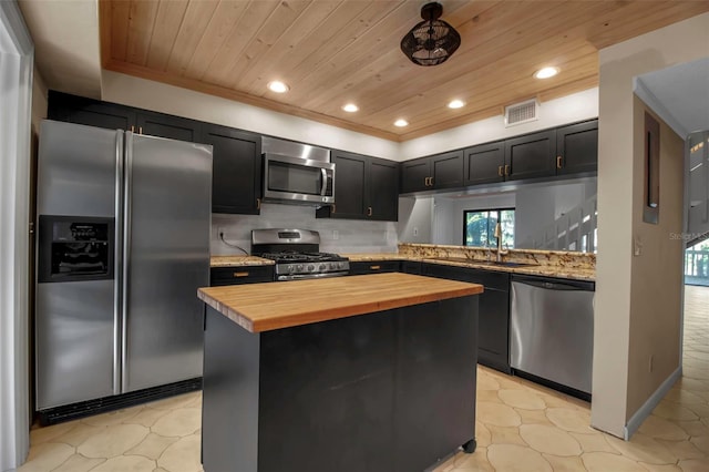 kitchen featuring tasteful backsplash, kitchen peninsula, wooden ceiling, and stainless steel appliances