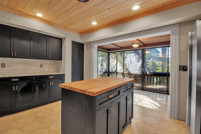 kitchen with wooden counters, decorative backsplash, light tile patterned floors, a kitchen island, and wood ceiling