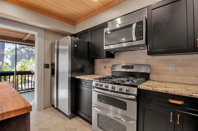 kitchen featuring light stone countertops, stainless steel appliances, decorative backsplash, light tile patterned flooring, and wood ceiling