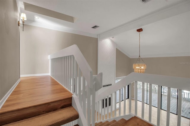 staircase featuring a chandelier, hardwood / wood-style floors, and a healthy amount of sunlight