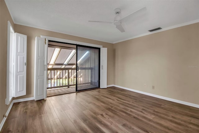 spare room with hardwood / wood-style flooring, ceiling fan, crown molding, and a textured ceiling