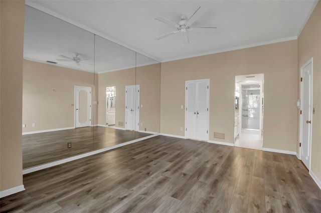 unfurnished living room with hardwood / wood-style flooring, ceiling fan, and crown molding