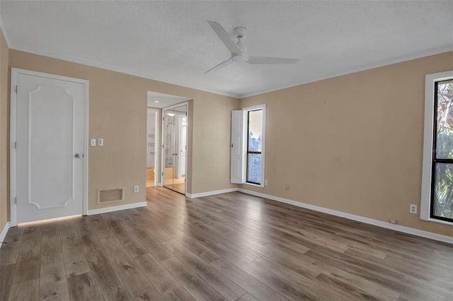 spare room with ceiling fan, wood-type flooring, and a textured ceiling