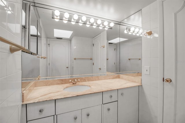 bathroom featuring vanity and a skylight