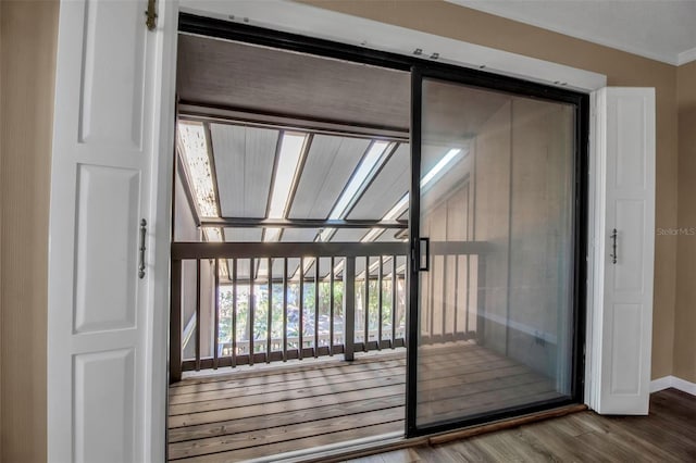 doorway to outside with hardwood / wood-style flooring and ornamental molding