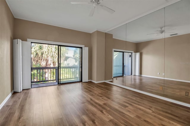 unfurnished room with ceiling fan and hardwood / wood-style floors