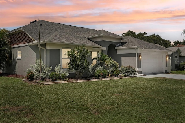 view of front of property featuring a yard and a garage