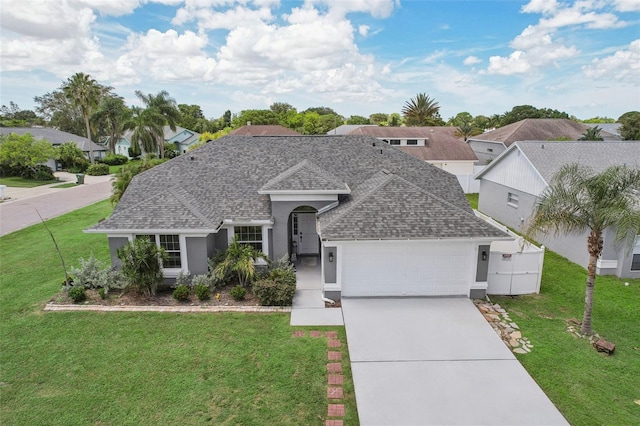 view of front of house featuring a front lawn and a garage