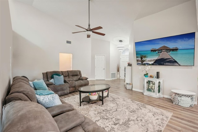 living room with hardwood / wood-style flooring, vaulted ceiling, and ceiling fan