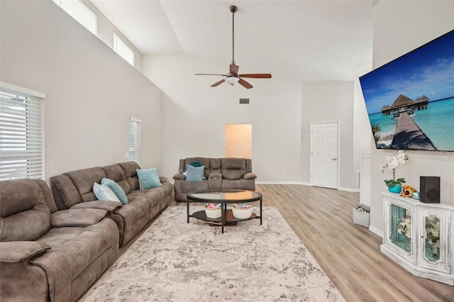 living room featuring ceiling fan, high vaulted ceiling, and light hardwood / wood-style floors