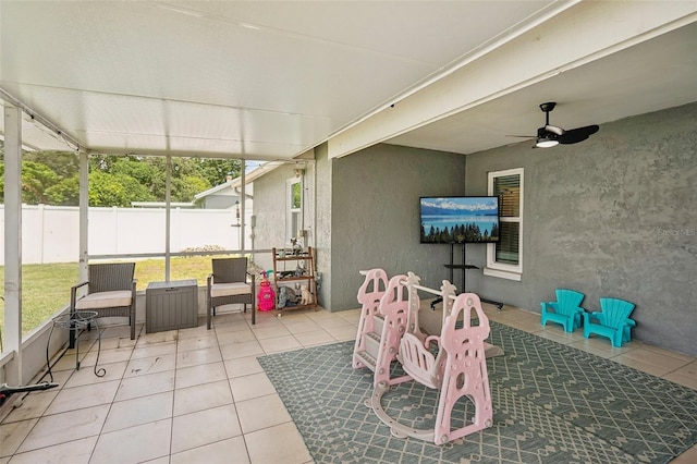 sunroom featuring ceiling fan