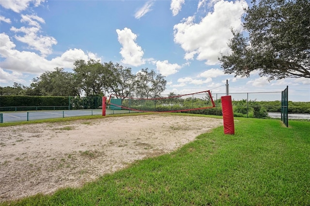 surrounding community with a yard and volleyball court