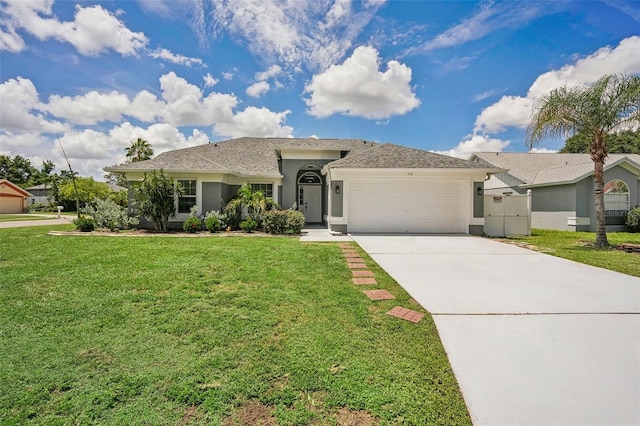 ranch-style home with a front yard and a garage