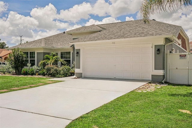 single story home featuring a front yard and a garage