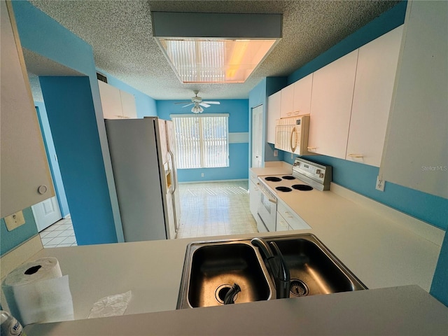 kitchen featuring white cabinetry, sink, ceiling fan, and white appliances