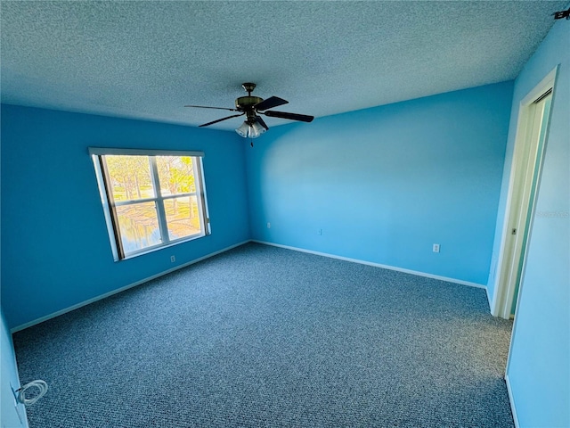 spare room featuring ceiling fan, carpet floors, and a textured ceiling