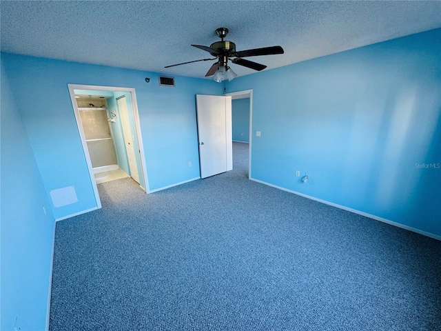 unfurnished bedroom featuring carpet flooring, a textured ceiling, and ceiling fan