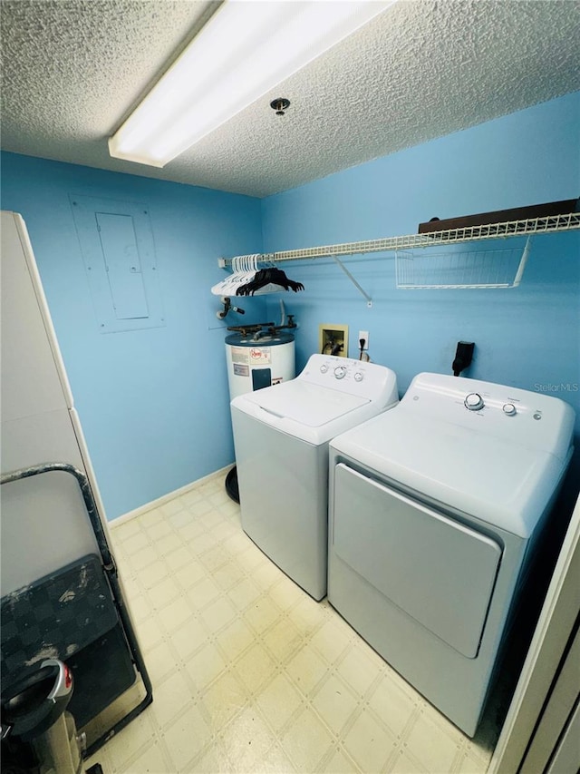 clothes washing area with separate washer and dryer, water heater, electric panel, and a textured ceiling