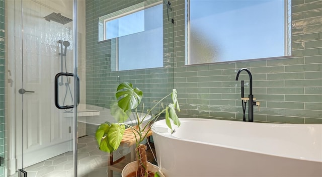 bathroom with independent shower and bath and tile walls