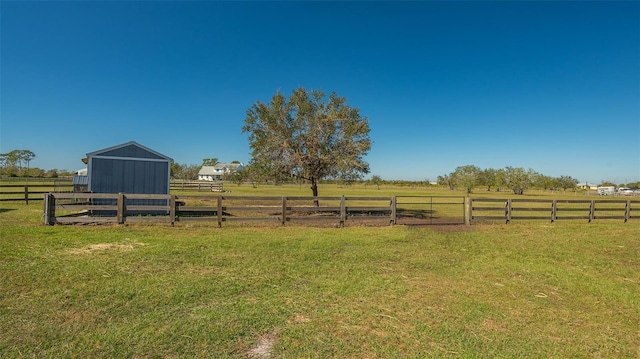 view of yard featuring an outbuilding and a rural view