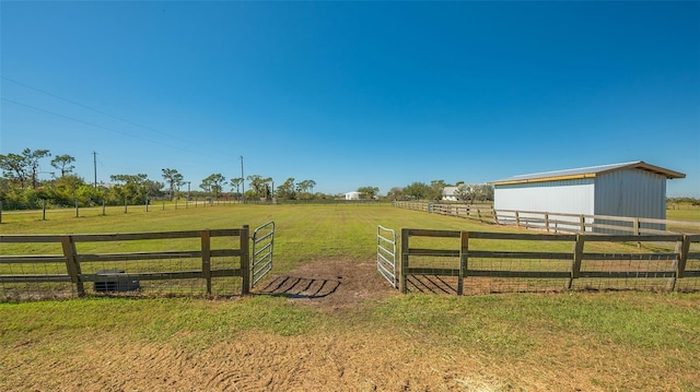 view of gate featuring a rural view and a yard