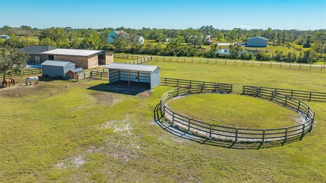 aerial view featuring a yard, an outdoor structure, and a rural view