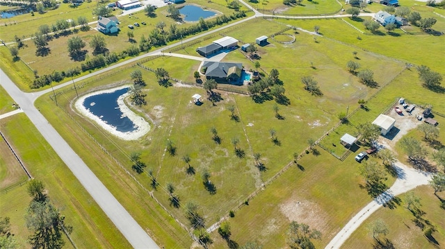 birds eye view of property with a water view and a rural view