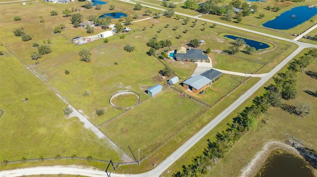 birds eye view of property with a water view and a rural view