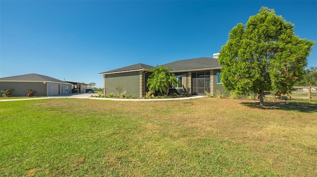 view of front of home featuring a garage and a front lawn