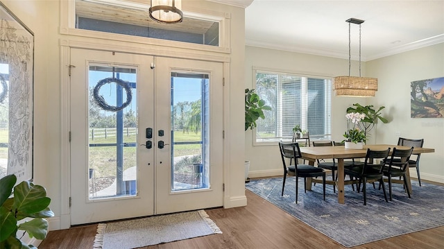 doorway to outside featuring hardwood / wood-style floors, crown molding, and french doors