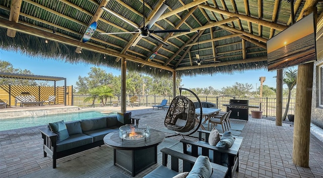 view of patio featuring a grill, a gazebo, an outdoor living space with a fire pit, and ceiling fan