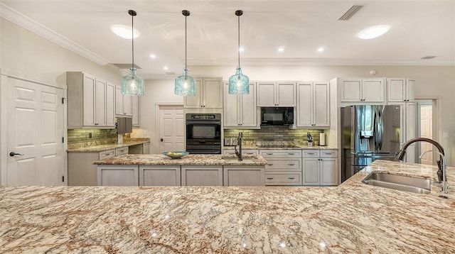 kitchen with pendant lighting, sink, black appliances, crown molding, and light stone countertops