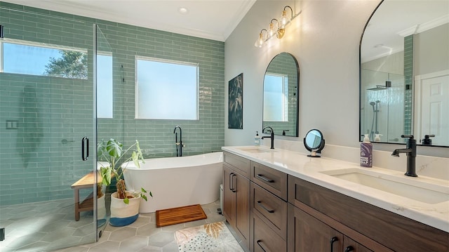 bathroom with tile walls, vanity, separate shower and tub, crown molding, and tile patterned floors