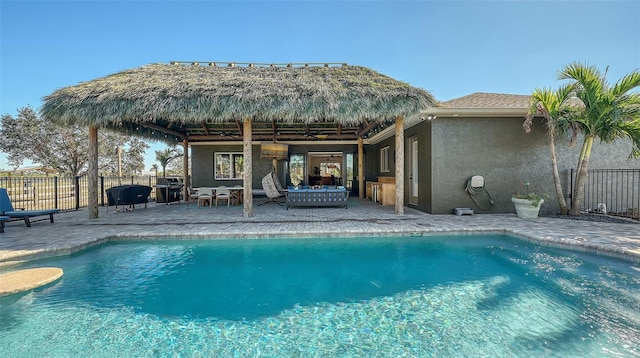 view of swimming pool with grilling area and a patio area