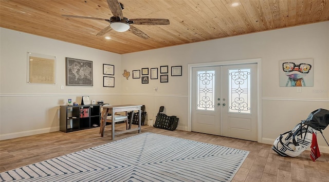 foyer with wood ceiling, light hardwood / wood-style floors, french doors, and ceiling fan