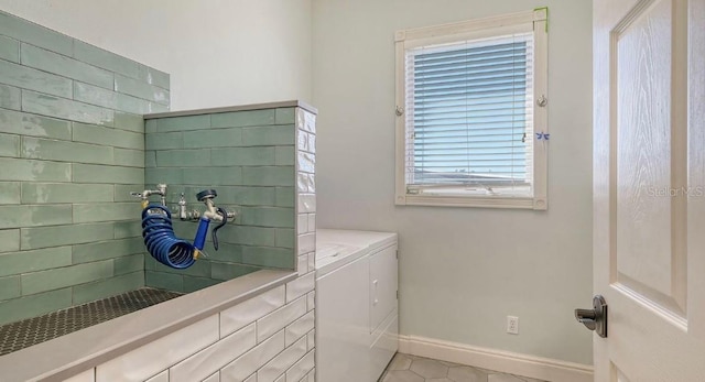 laundry area with tile patterned floors and independent washer and dryer