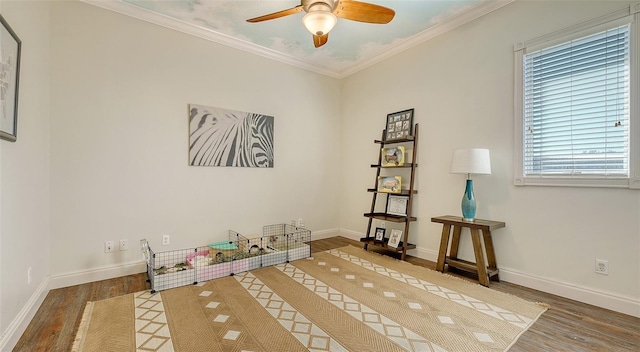 interior space featuring hardwood / wood-style floors, ornamental molding, and ceiling fan