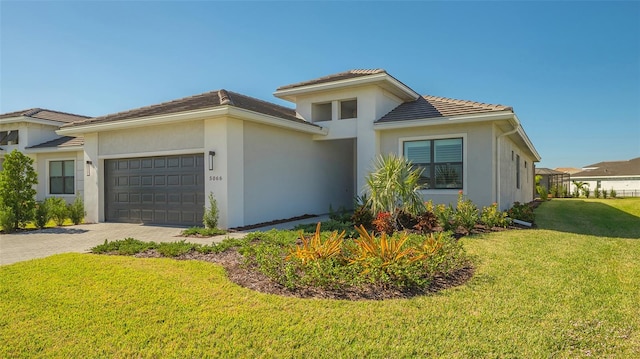 view of front of home with a front yard and a garage