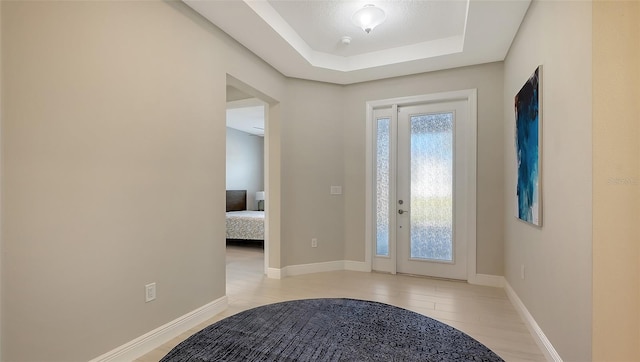 foyer featuring a tray ceiling