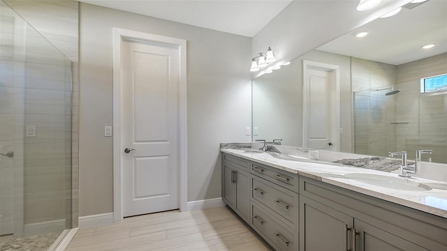 bathroom with vanity, wood-type flooring, and tiled shower