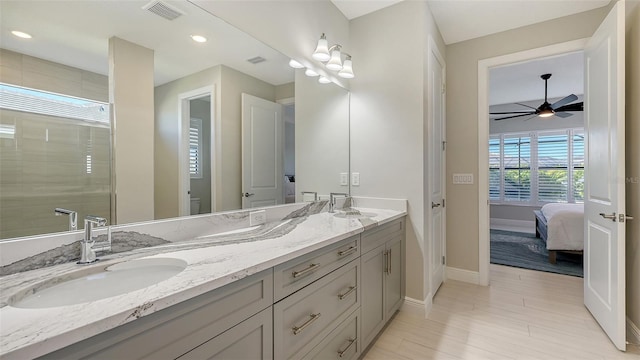 bathroom with hardwood / wood-style flooring, vanity, ceiling fan, and a shower